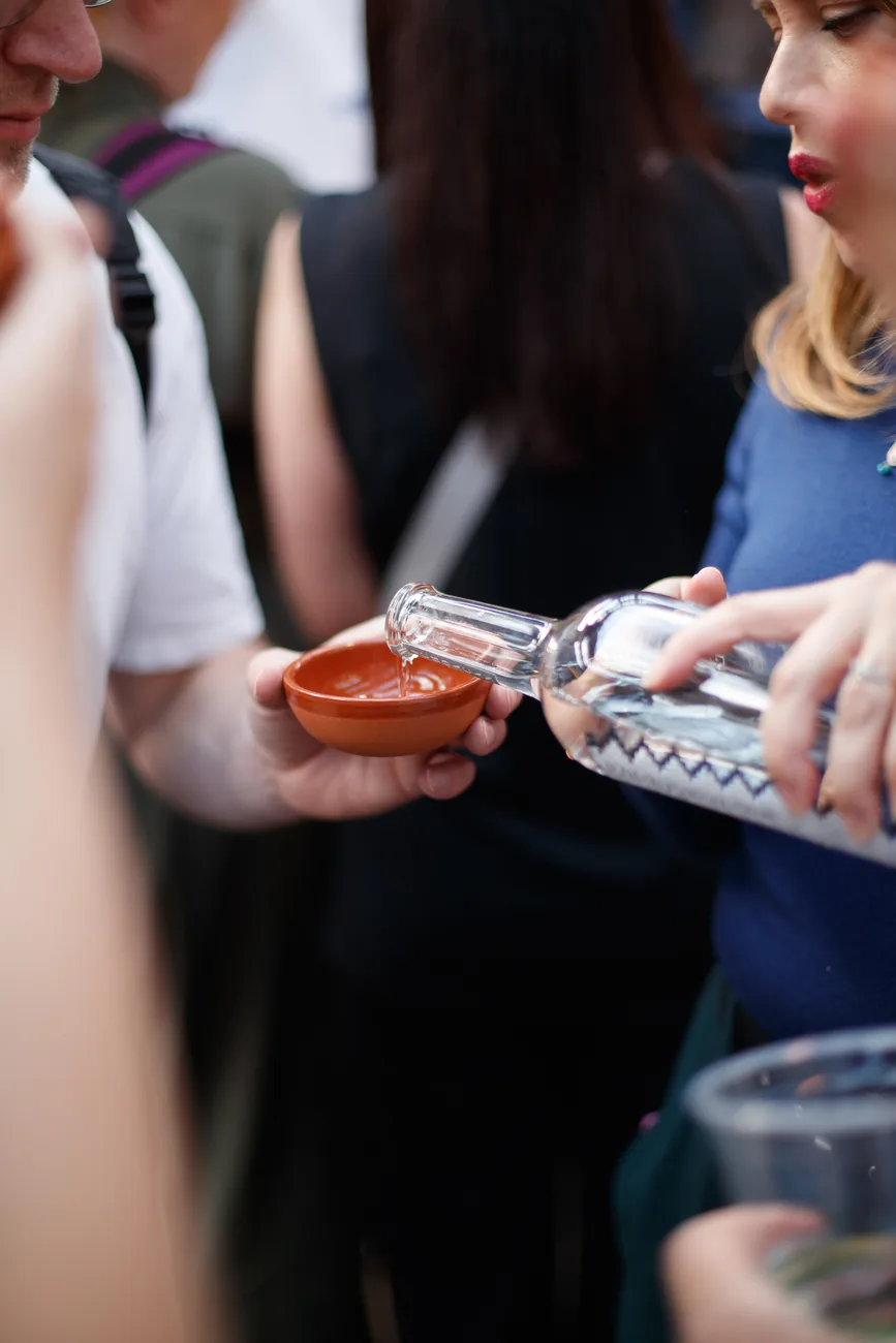 A spirit being poured into a clay cup at Copita