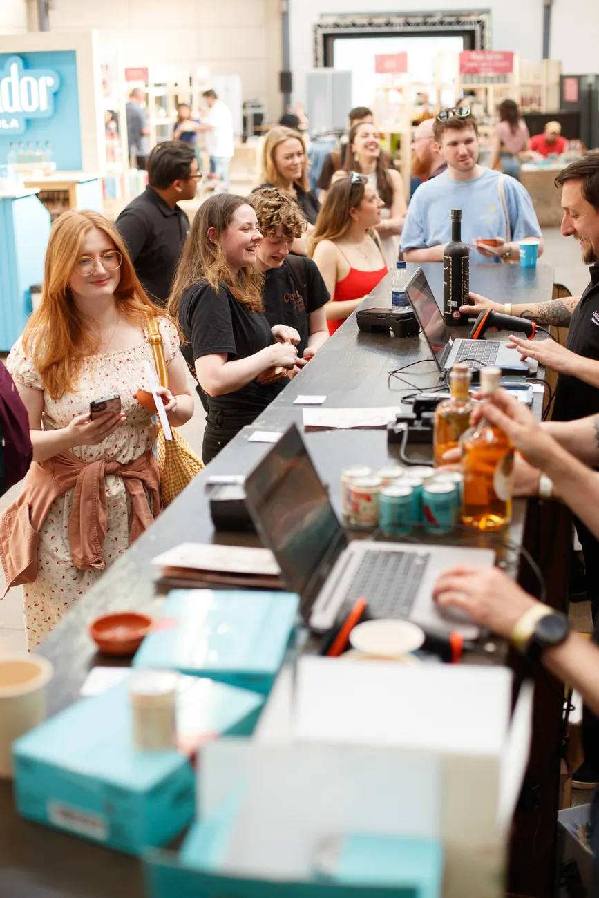 Visitors talking at a tasting stand